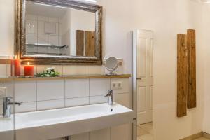 a bathroom with a sink and a mirror at Lina in Rottenbuch +37 photos