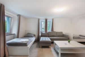 a living room with a couch and a table at Ferienapartments Ariana in Bad Säckingen