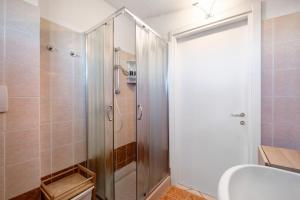 a shower with a glass door in a bathroom at Locazione turistica Raffa-Ele in Cantù +11 photos