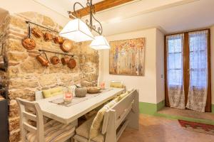 a kitchen and dining room with a stone wall at La Terrazza, Cetona, Toscana in Cetona