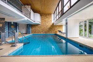 an indoor pool with blue tiles in a building at Ferienwohnung Adrion in Bad Herrenalb