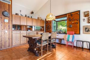a kitchen with a wooden table and chairs at Villa Franca San Zeno in San Zeno di Montagna