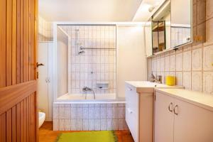a bathroom with a tub and a sink at Villa Franca San Zeno in San Zeno di Montagna +39 photos