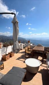 a patio with an umbrella and a table and chairs at Casa Mark in Forza dʼAgro