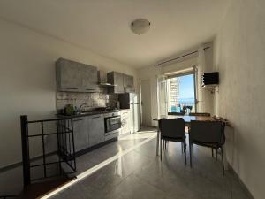 a kitchen with a table and chairs in a room at Casa Mark in Forza dʼAgro