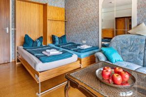 a room with two beds and a table with a bowl of apples at Ferienwohnung Adrion in Bad Herrenalb +108 photos