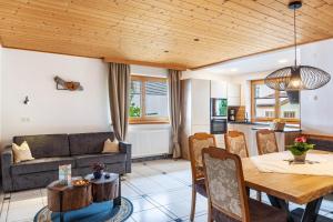 a living room with a table and a couch at Hotel Sonnblick - Wohnung Klaus in Kartitsch