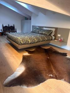 a large bed in a room with a wooden floor at La dolce vita - Lake Iseo in Paratico +15 photos