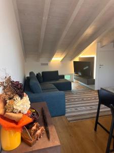 a living room with a blue couch and a table at La dolce vita - Lake Iseo in Paratico