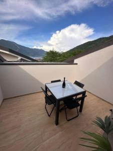 a table and chairs on top of a balcony at La dolce vita - Lake Iseo in Paratico