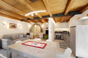 a kitchen and living room with a table and a couch at Appartamenti Cucu - 1 in Lillianes +21 photos