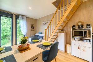 a kitchen and dining room with a table and chairs at Gîte Le Pieraline - Ventron in Ventron
