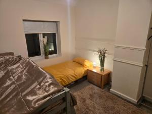 a bedroom with a bed and a window at The Indigo Escape in Ibstock