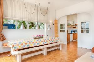 a living room with a bench in the middle at Casa Ullastre de Fornells in Fornells