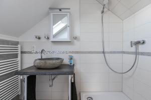 ein Badezimmer mit Waschbecken und Dusche in der Unterkunft Uhse Loft in Heide