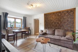 a living room with a couch and a table at Ferienwohnung beim Roana in Inzell