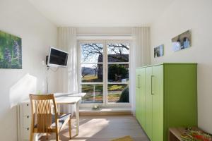 a room with a desk and a window at Birkethof Gartenblick in Grimoldsried
