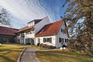 a large white house with a red roof at Birkethof Gartenblick in Grimoldsried