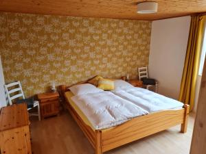 a bedroom with a large bed with a wooden frame at Ferienhof Rosenwarft in Pellworm