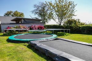 a trampoline in the yard of a house at Ferienwohnung Kiebitznest in Kaiser Wilhelm Koog
