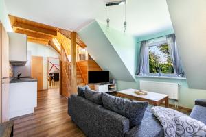 a living room with a couch and a table at Ferienwohnung Kiebitznest in Kaiser Wilhelm Koog