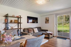 a living room with a couch and a table at Ferienwohnung am Waldrand in Alpirsbach