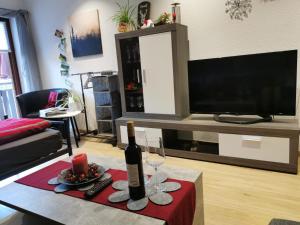 a living room with a bottle of wine on a table at Ferienwohnung Schöner in Oberharmersbach
