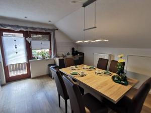a dining room with a wooden table and chairs at Ferienwohnung Schöner in Oberharmersbach +29 photos