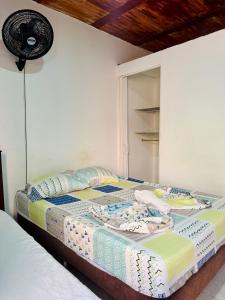 a bedroom with a bed with a fan on it at Hostal Arambulo in Villavieja