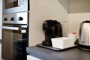 a coffee maker sitting on a counter in a kitchen at Alpine A-S in Aymavilles
