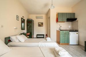 a room with two beds and a kitchen at Anemona studio B in Kefallonia