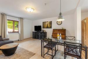 a living room with a table and a couch at Hof Helmenhube 2 in Oberzent
