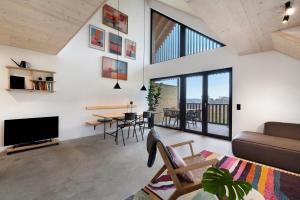 a living room with a couch and a tv and a table at Ferienappartements Bayer in Sigmarszell