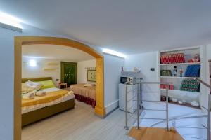 a bedroom with a bed and a room with a shelf at Il Geco in Salice Salentino