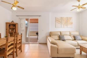 a living room with a couch and a table at Puerta Marina Costa de la Luz in La Redondela +22 photos