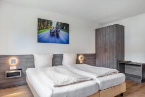 a bedroom with a large white bed in it at Gästehaus Schwörer in Lenzkirch +119 photos