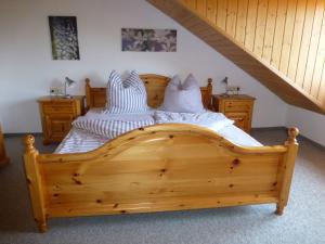 a bedroom with two beds and a staircase at Moorwiesenhof in Ostrach