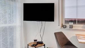 a flat screen tv on the wall of a living room at Ferienwohnung Heidegarten in Radolfzell am Bodensee