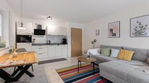 a living room with a couch and a table at Ferienwohnung Heidegarten in Radolfzell am Bodensee