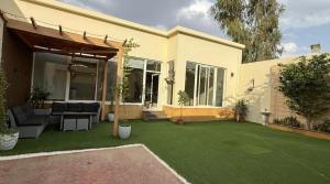 a house with a yard with a green lawn at فلل لوسيرن in Khamis Mushayt