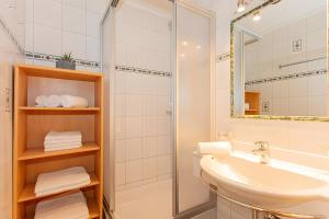 a bathroom with a sink and a shower at Blockhaus Ganschitter Großarl in Grossarl +30 photos