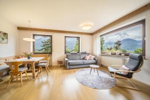 un soggiorno con divano, tavolo e sedie di Villa Pinie Apt 2 a Terlano
