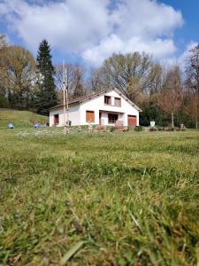 a small white house in a field of grass at L échappée verte in Gien