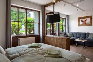 a bedroom with a bed and a living room at Ferienwohnung Am Mehlberg in Hinterzarten