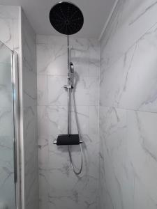 a shower with a shower head in a bathroom at Suite GrandLarge in Berck-sur-Mer +30 photos