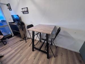 a wooden table in a room with a desk and chairs at Suite GrandLarge in Berck-sur-Mer