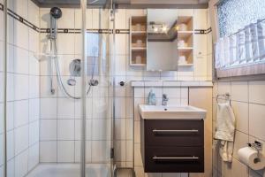 a bathroom with a shower and a sink at Wikinger 74 in Immenstaad am Bodensee +22 photos