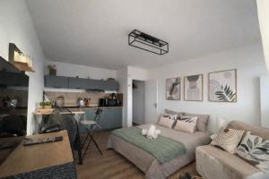 a living room with a bed and a kitchen at Suite GrandLarge in Berck-sur-Mer