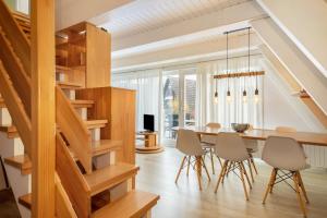 a dining room with a table and chairs at Wikinger 74 in Immenstaad am Bodensee