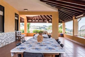 a table and chairs on a patio with a view at Villa Tre 's' in Montallegro +33 photos